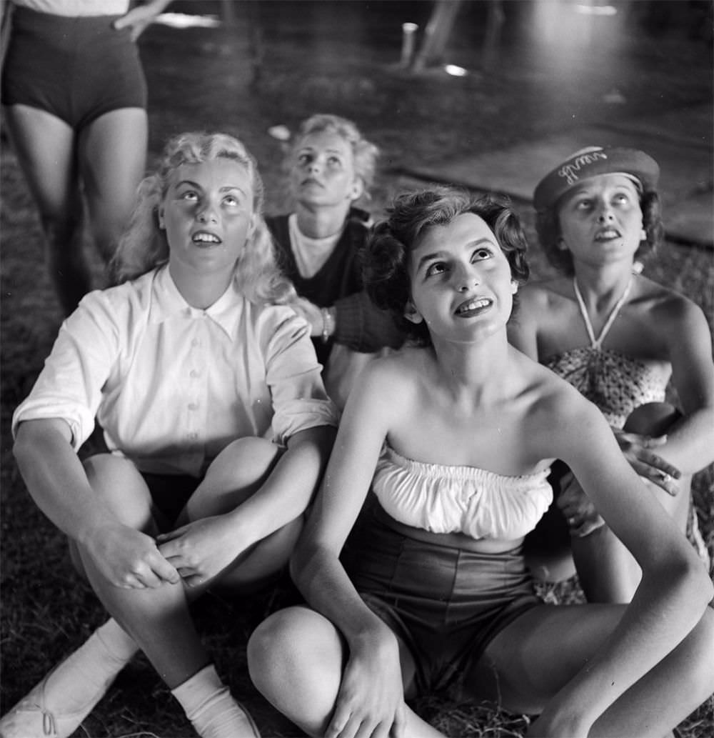 A picture of a group of circus girls sitting at a rehearsal for the Ringling Bros. and Barnum & Bailey Circus in Sarasota, FL in 1949.