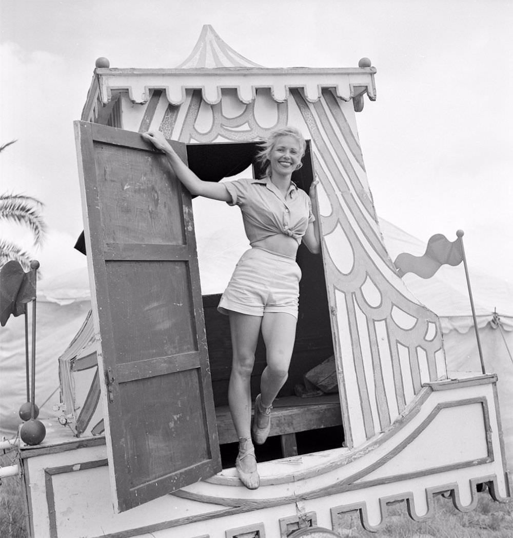 A circus girl standing at a door of a circus vehicle during a rehearsal for the Ringling Bros. and Barnum & Bailey Circus in Sarasota, FL in 1949.