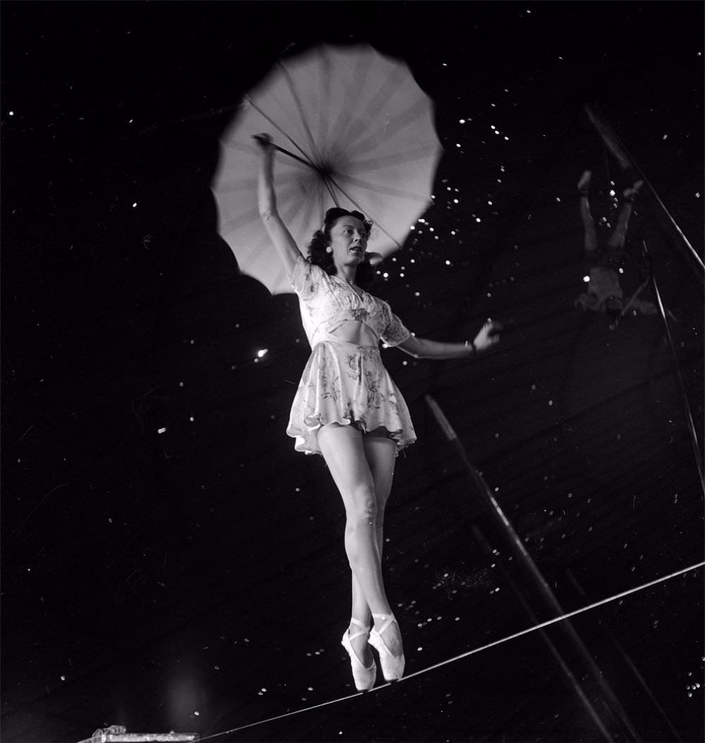 An acrobat holding an umbrella and rehearsing on a rope for the Ringling Bros. and Barnum & Bailey Circus in Sarasota, FL in 1949.