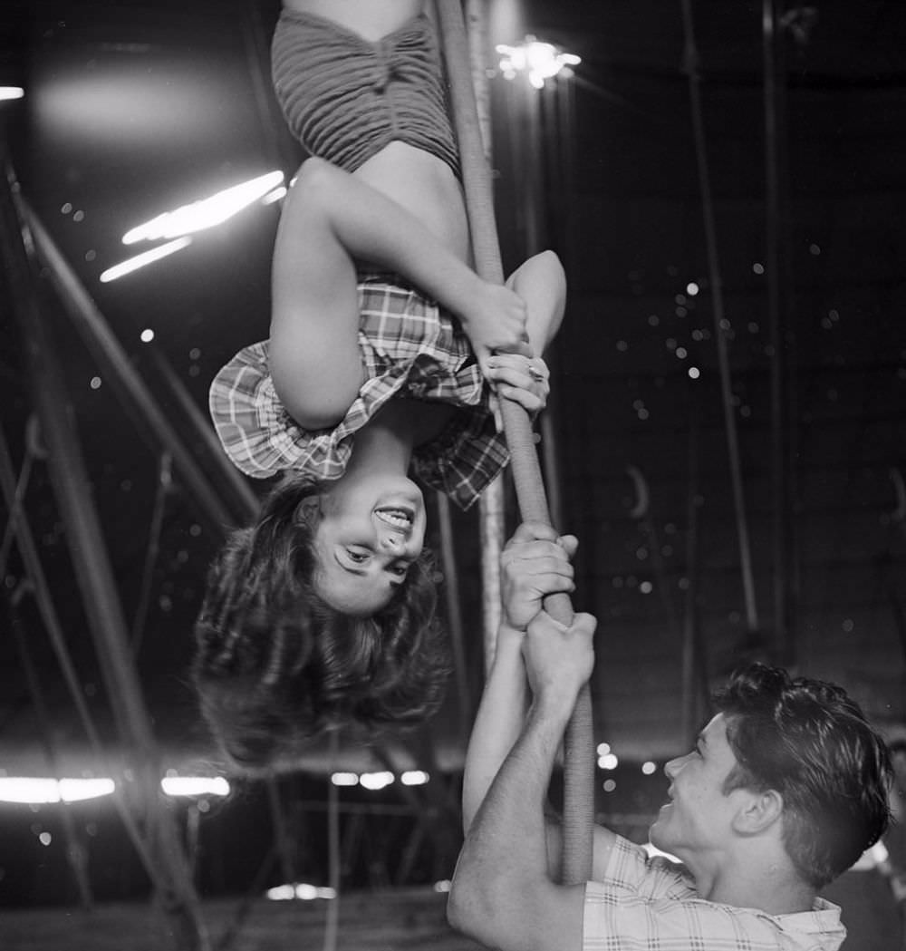 An acrobat rehearsing for the Ringling Bros. and Barnum & Bailey Circus while an unidentified man holding a rope in Sarasota in 1949.