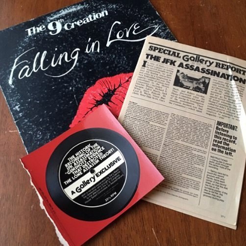 A JFK assassination cardboard cutout record with a clipping of an article on the same subject found inside a copy of “Falling In Love” by The 9th Creation.