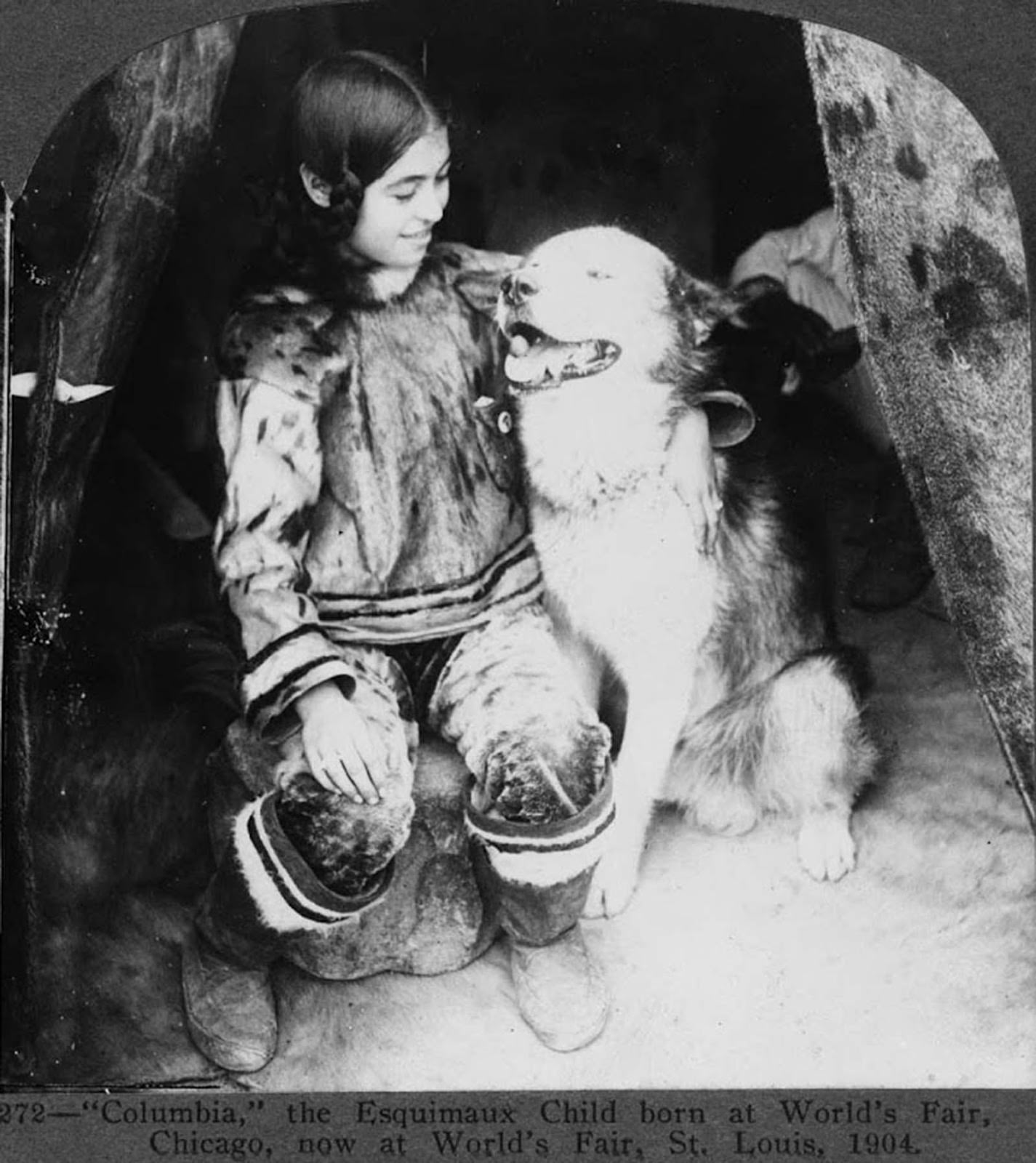This Eskimo child, with a dog, was born at World’s Fair in Chicago and is pictured after being transferred to World’s Fair, St. Louis in 1904.