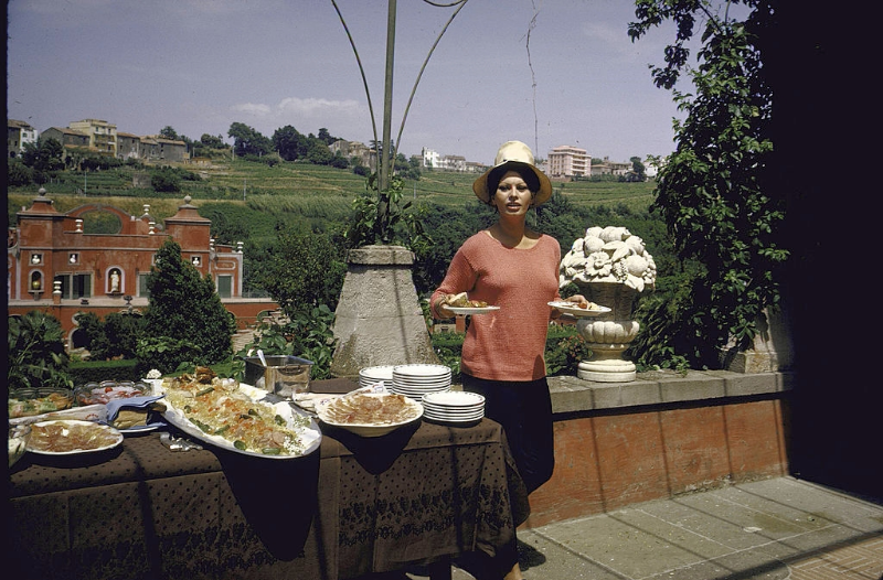 Sophia Loren having lunch on a second floor terrace of her villa.
