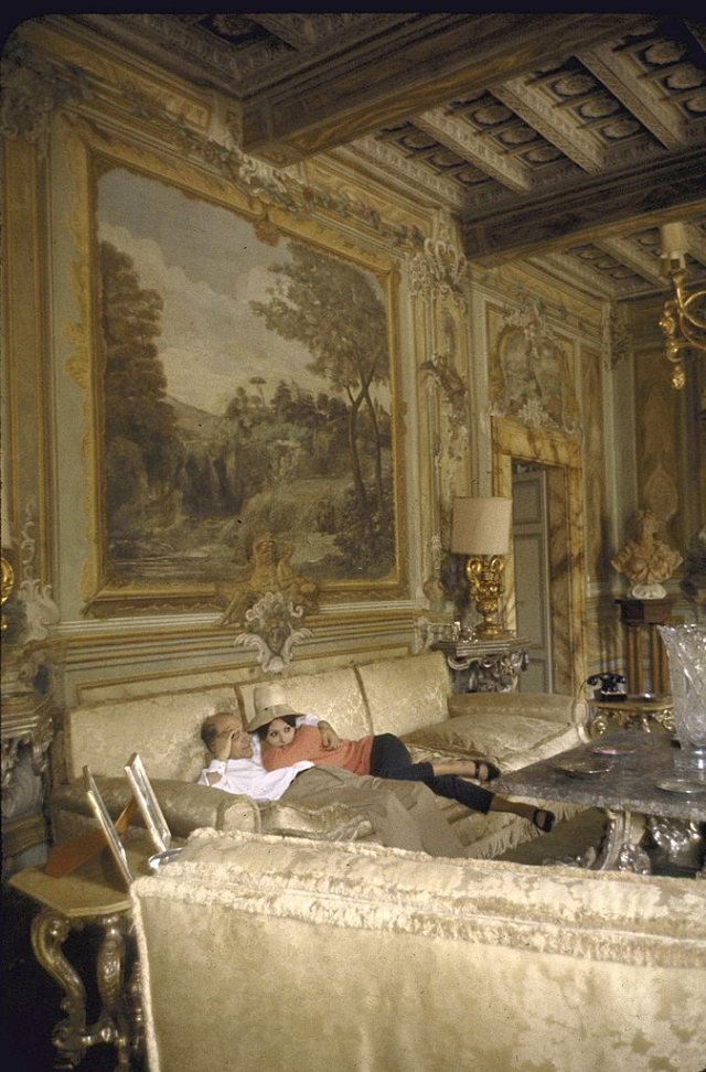 Sophia Loren and Carlo Ponti lying on a couch in their villa.