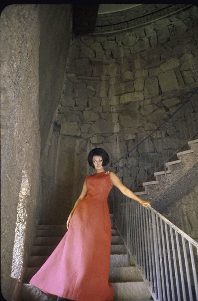 Sophia Loren in a beautiful pink dress coming downstairs at her villa.