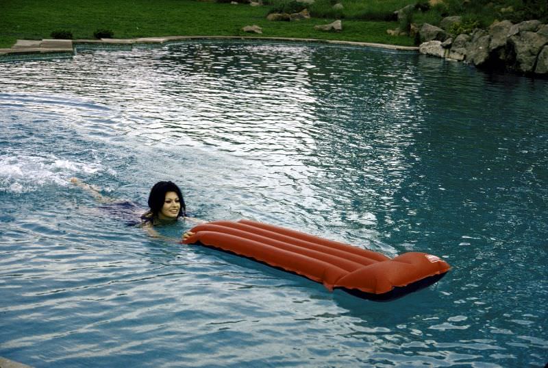 Sophia Loren swimming in the pool at her villa.