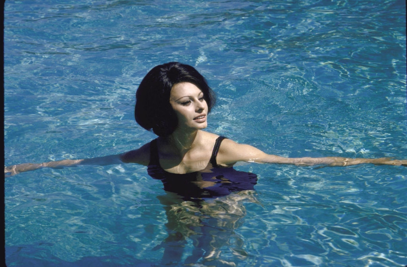 Sophia Loren swimming in the pool at the villa.
