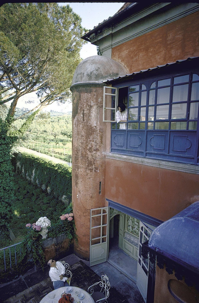 Carlo Ponti on the terrace while Sophia Loren talks to him from above.