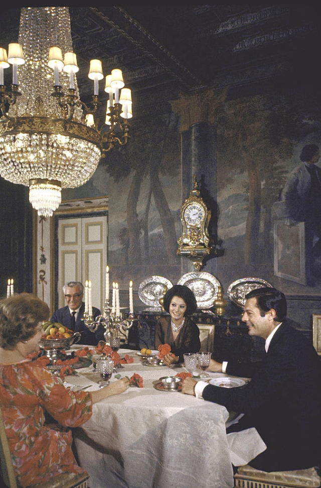 Sophia Loren entertaining Vittorio de Sica, his wife and Marcello Mastroianni in the formal dining room.
