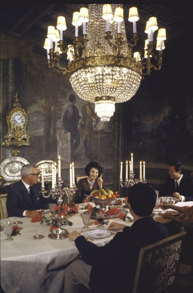 Sophia Loren entertaining Vittorio de Sica, his wife and Marcello Mastroianni in the formal dining room of her villa.