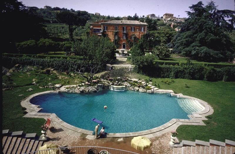 Sophia Loren and Carlo Ponti on the edge of their 135-foot swimming pool.