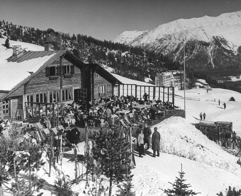 Zuber Cabin in snow-covered winter-resort village. Hotel Chantarella in background.