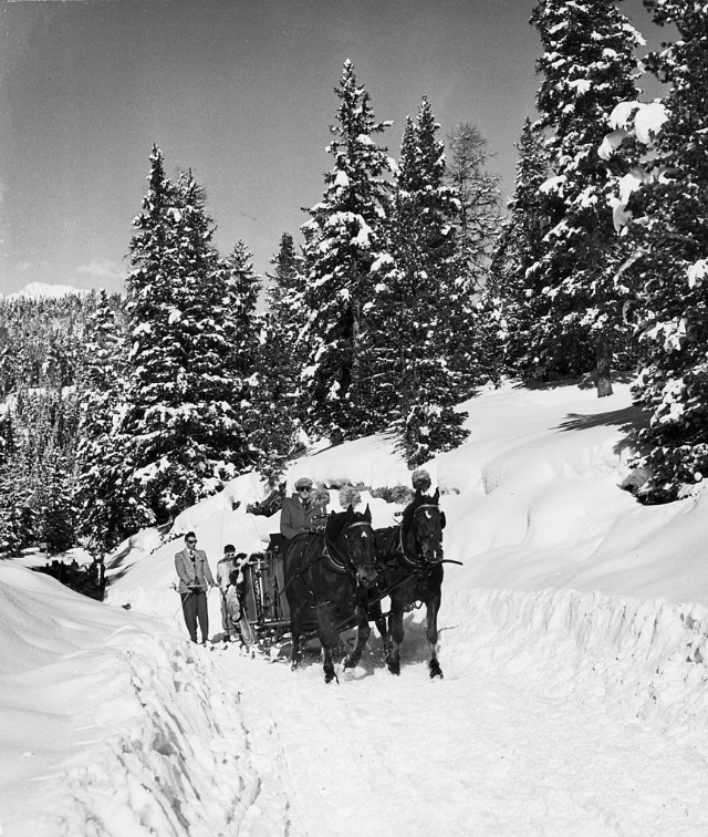 Sleigh-ride from town to jumping hill in snow-covered ski-resort village.