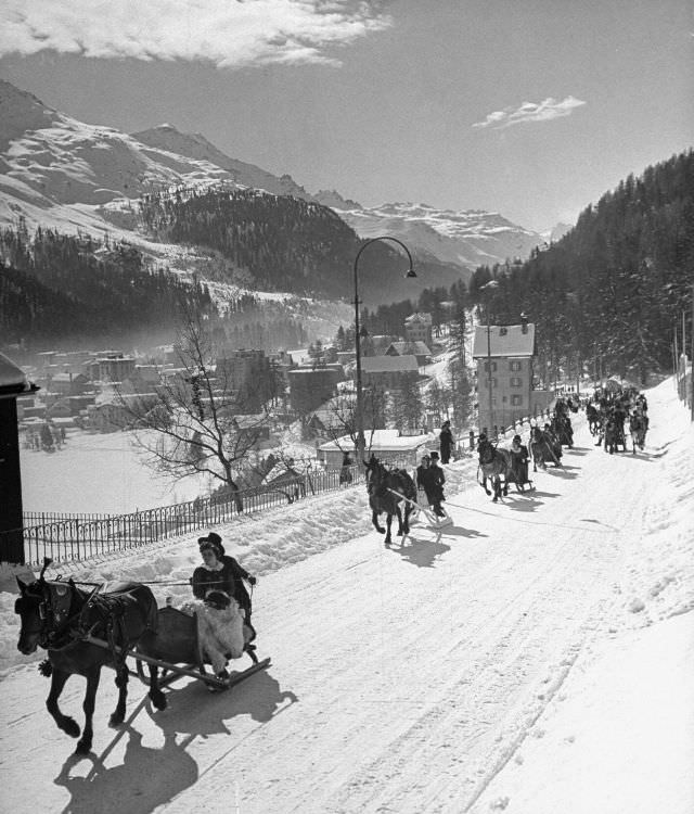 Sleigh-ride from town to jumping hill in snow-covered ski-resort village.