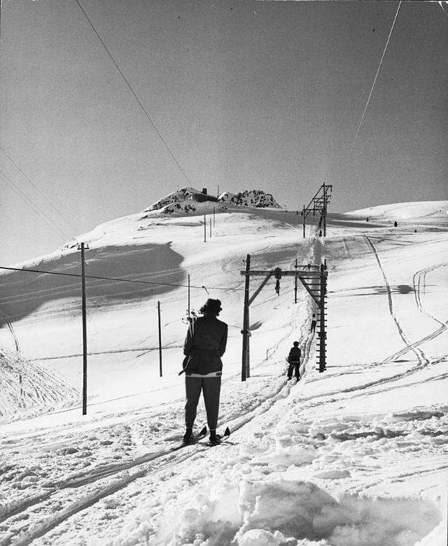 Ski lift on Alpine slopes of winter resort.