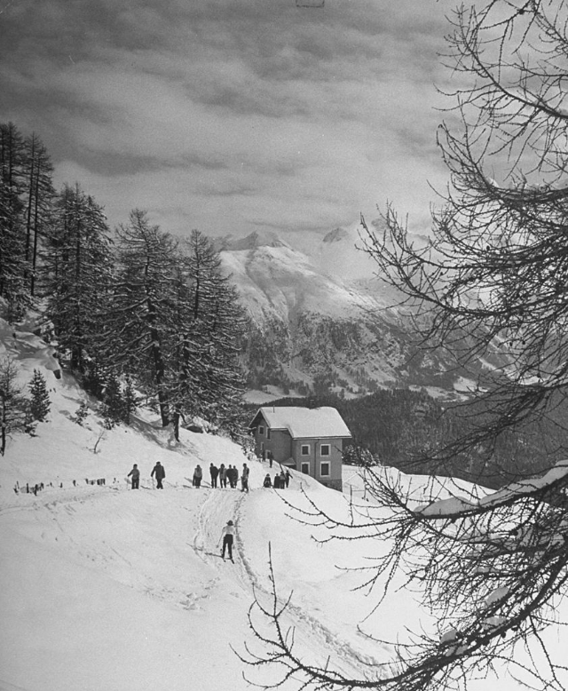Snow-covered hill above ski resort village.