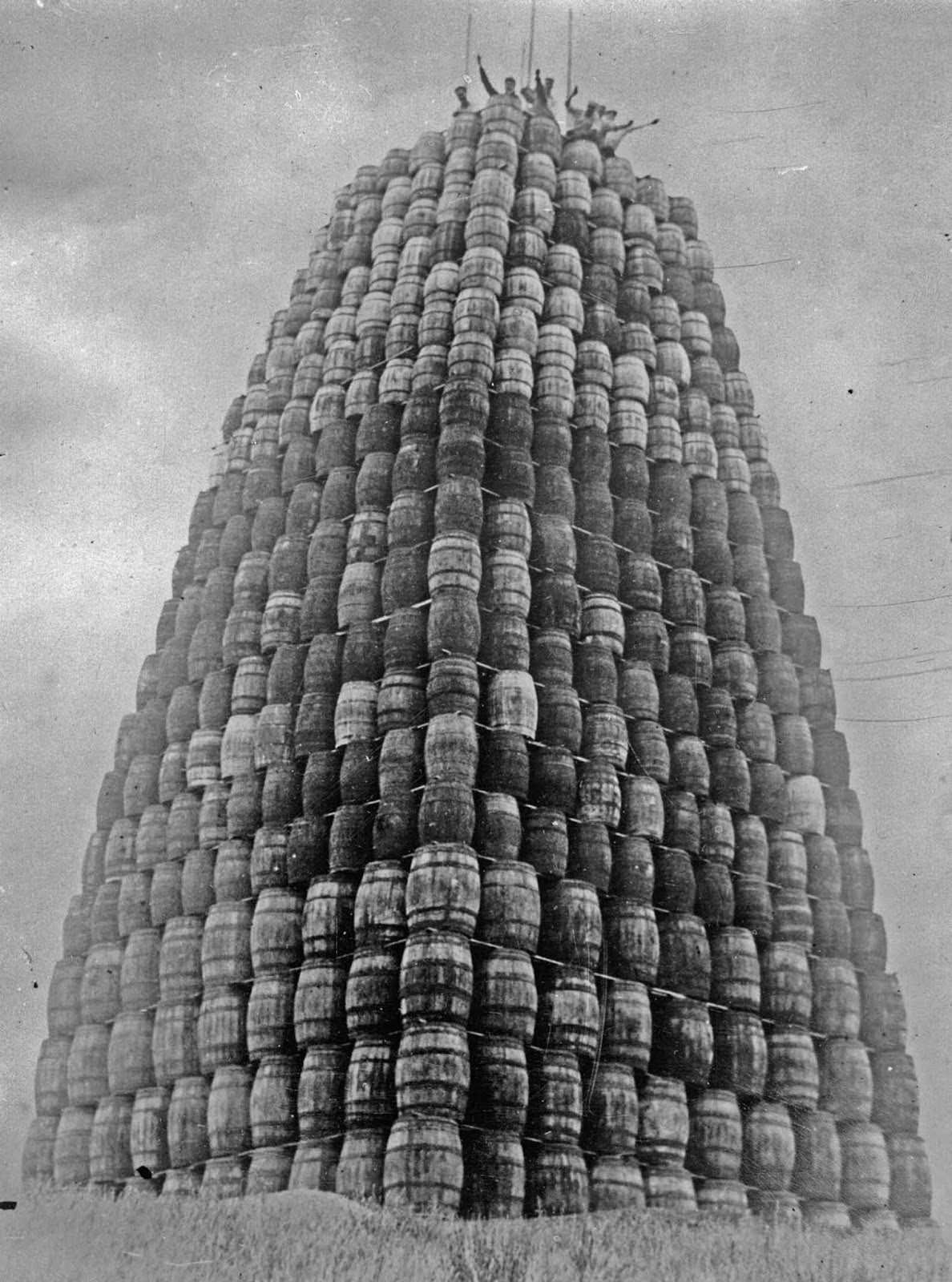 A tower built with barrels of alcohol, which will be destroyed later. 1929.