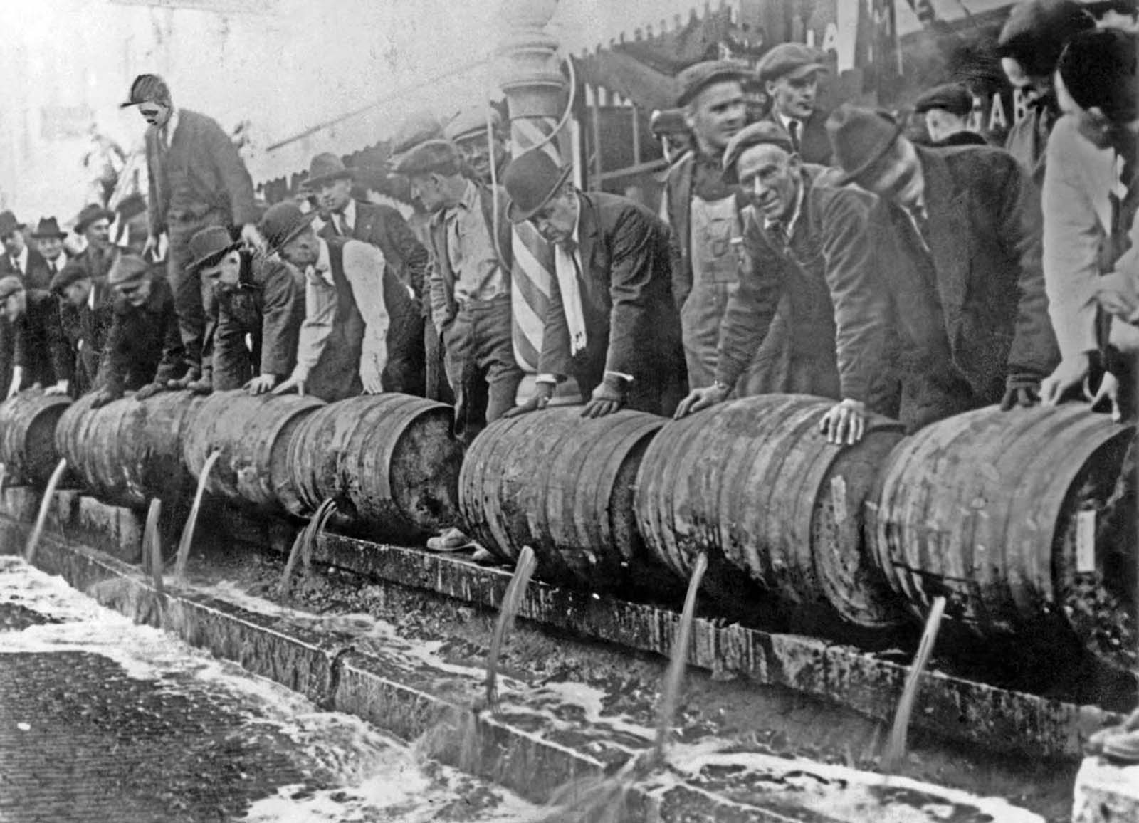 Barrels of beer emptied into the sewer by authorities during prohibition.