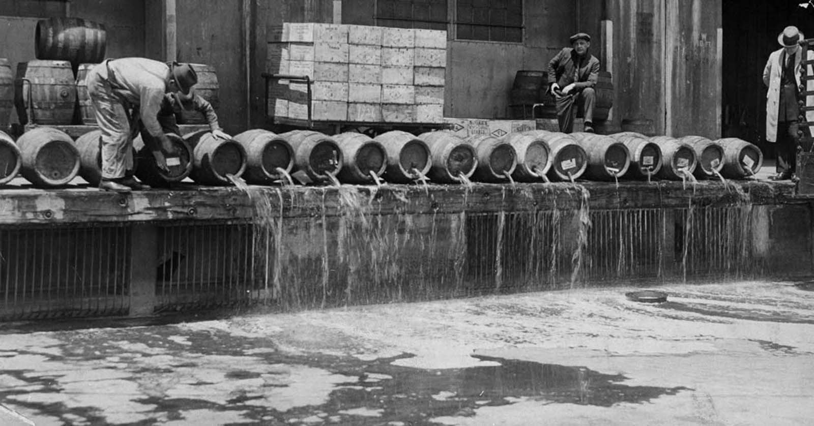 At an army base in Brooklyn, men drain 10,000 barrels of beer into New York Harbor.