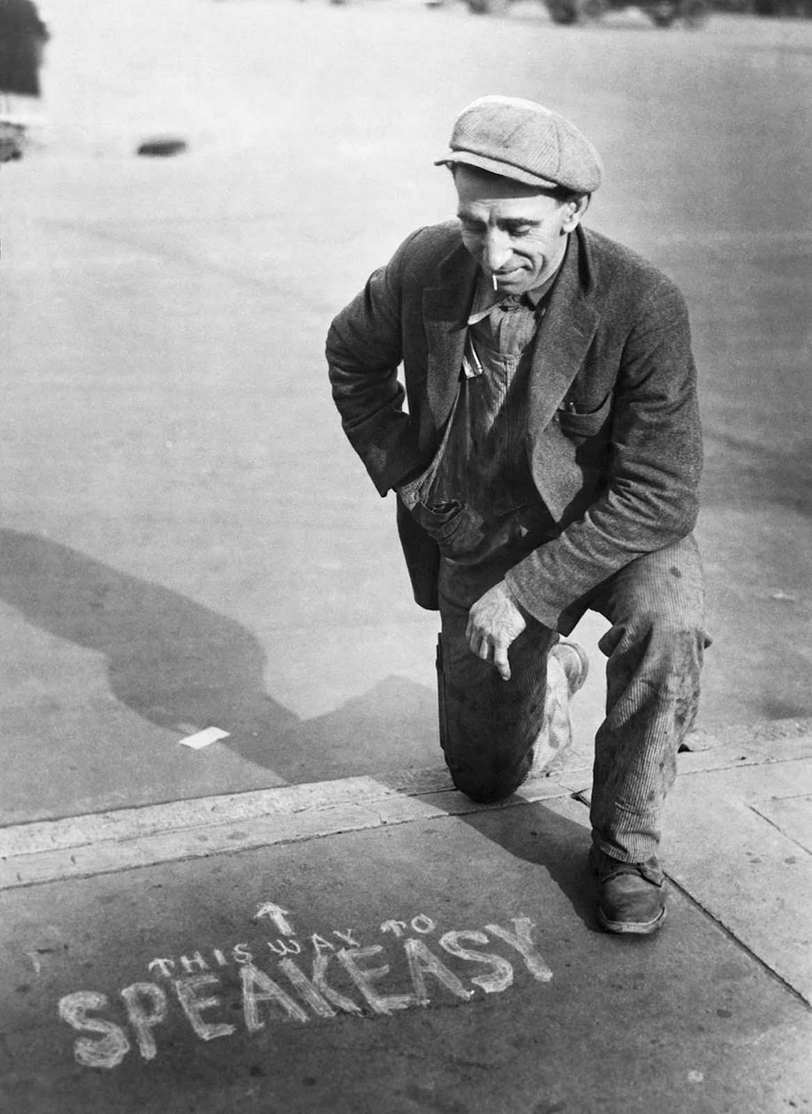 A potential customer examines an advertisement for an illegal drinking den or speakeasy during US prohibition in the 1920s.