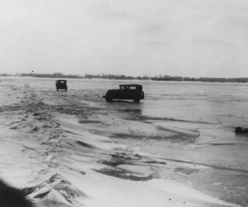 Large quantities of Canadian beer and whisky are being transported in cars from Amherstburg, Ont., Canada, across the frozen lower Detroit River, to the Michigan side of the international boundary line, Feb. 14, 1930.