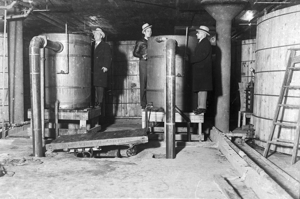 The largest distillery ever uncovered in Detroit was raided and prohibition officers are seen inspecting tanks and vats in one part of the plant, on Jan. 5, 1931. Each of these vats have a capacity of 15,000 gallons and there were thirteen on this floor alone.