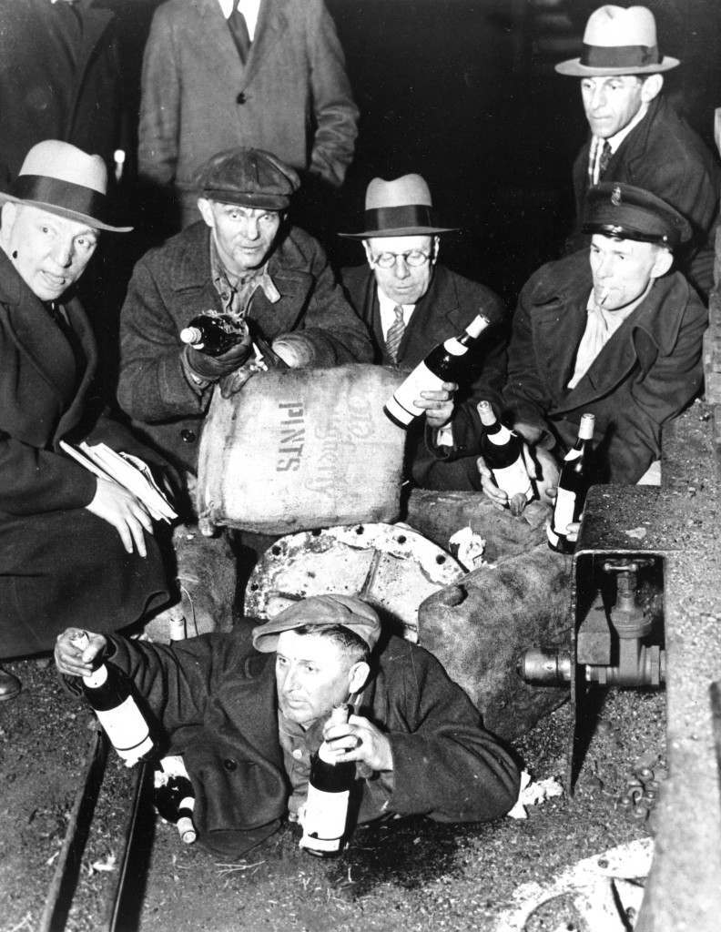 Prohibition agents uncover about $300,000 worth of liquor concealed in a pile of coal when they boarded the coal steamer Maurice Tracy in New York harbor on April 8, 1932.