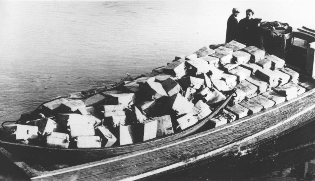 Coast guardsmen stand on a speed boat packed with nearly 700 cases of liquor they captured as it was unloaded at Newburyport, Mass., on the morning of May 6, 1932.