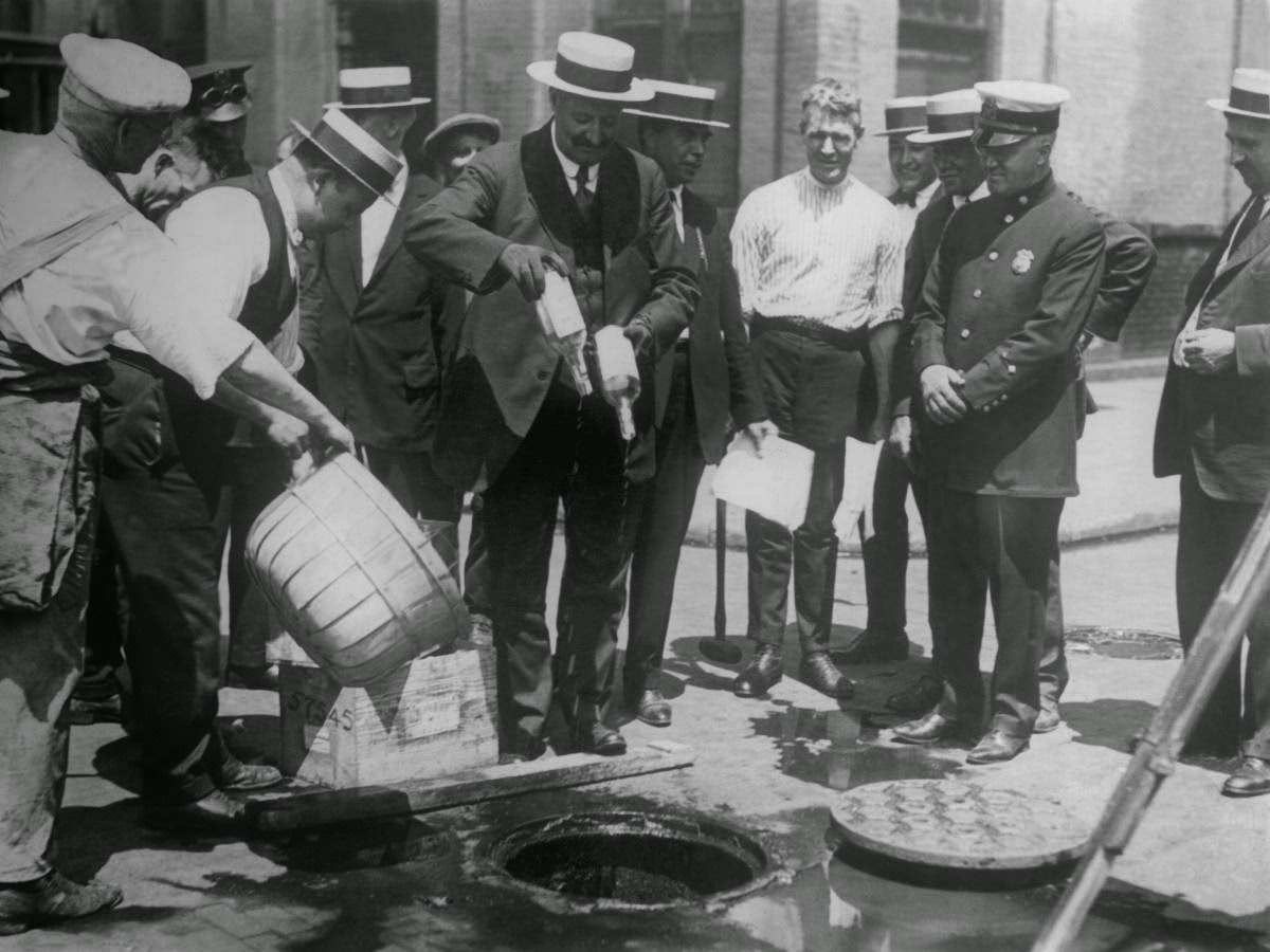 Alcohol seized by police is dumped into sewage drains in New York.