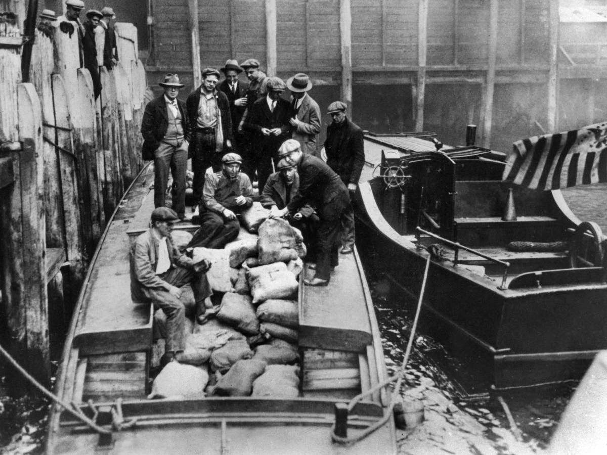 Customs agents confiscate a large amount of alcohol from a bootlegger's boat.