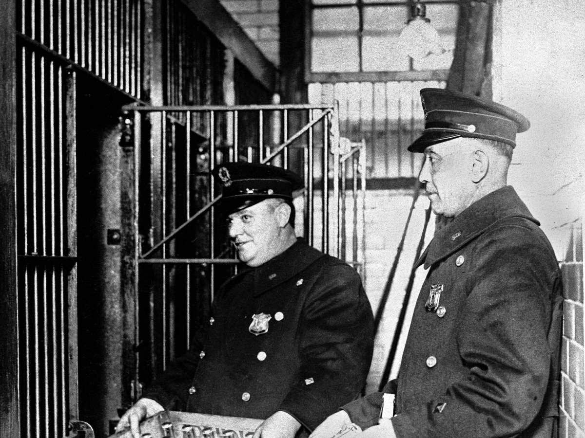 Prohibition agents seize boxes of booze during a raid.
