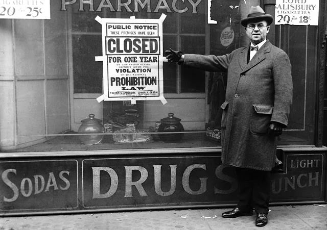 Huge black-and-white posters printed in bold type serve as notice that a Chicago business had been closed by the federal courts for violations of the Volstead Act.
