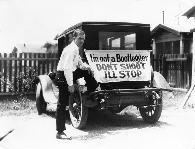 A driver tries to ensure his safety with a banner on his vehicle that reads, "I'm not a Bootlegger. Don't shoot, I'll stop," near the Mexico border in 1929.