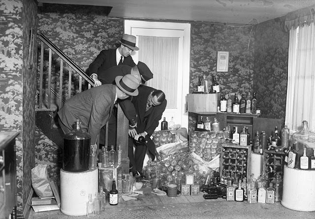 Police officers raid a Long Island, New York, home to find $20,000 worth of booze on Jan. 26, 1930.
