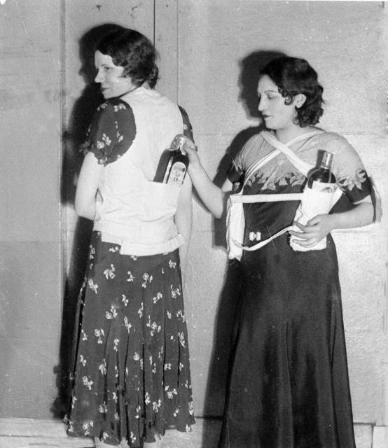 Estelle Zemon, left, and an unidentified woman model ways to conceal bottles of rum to get past customs officials during the U.S. alcohol prohibition, March 18, 1931.