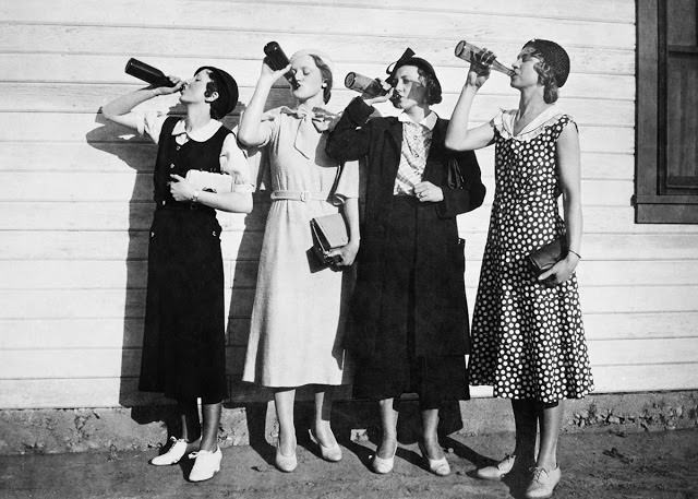 Four women chug bottles of illegal liquor, 1925.