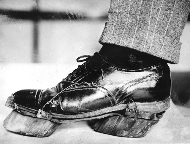 The shoe of an alcohol smuggler who had been arrested at the Canadian border is strapped with wooden soles in the form of cattle hooves to camouflage their border crossing, circa 1924.