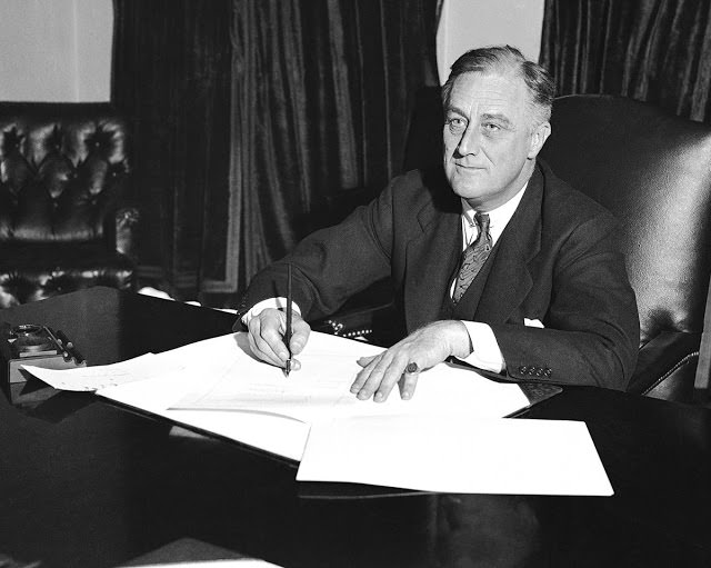 President Franklin D. Roosevelt signs the Cullen-Harrison Act, or "Beer Bill," the first relaxation of the Volstead Act, on Mar. 22, 1933. The new law allowed the sale of beer and wine containing 3.2% alcohol starting at midnight on April 6.