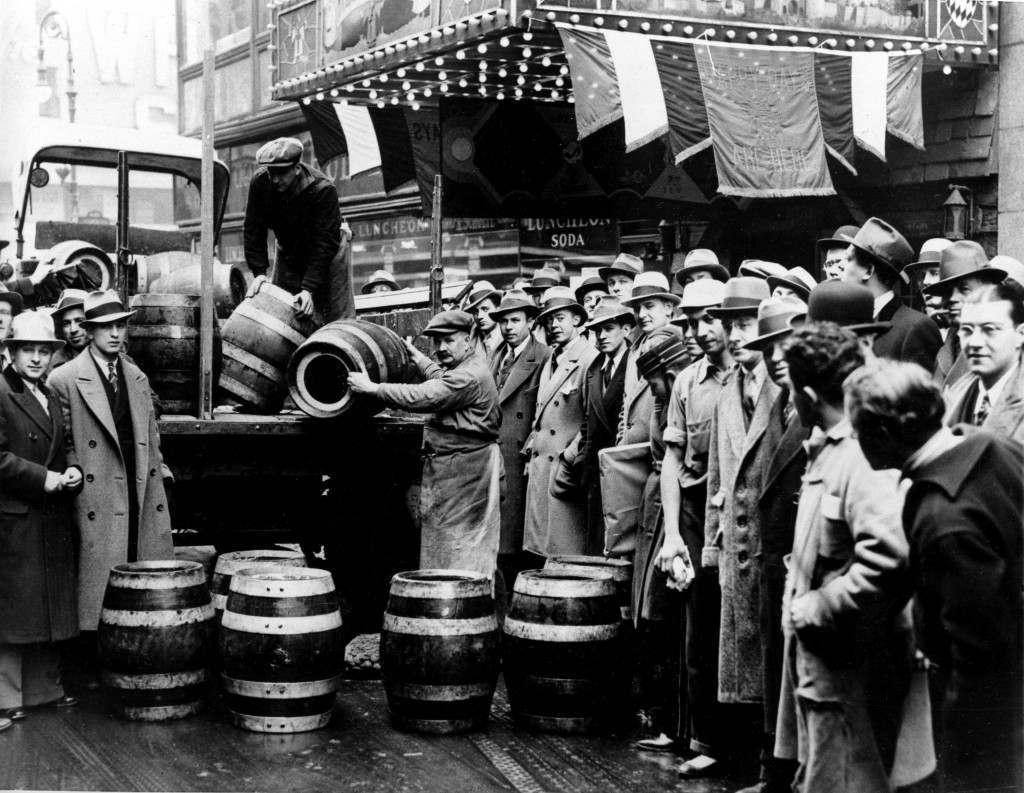A crowd gathers as kegs of beer are unloaded in front of a restaurant on Broadway in New York City, the morning of April 7, 1933, when low-alcohol beer is legalized again.