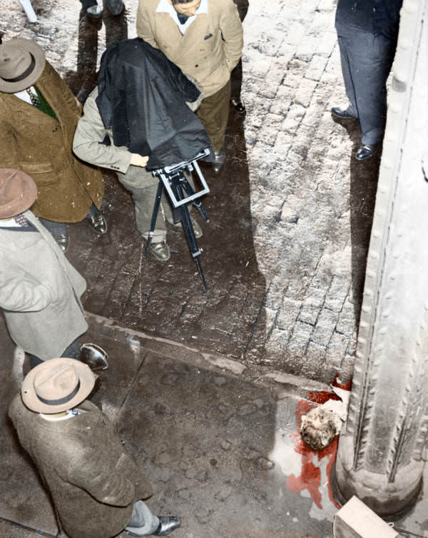 Weegee photographs a human head at the scene of a murder. Circa 1945.
