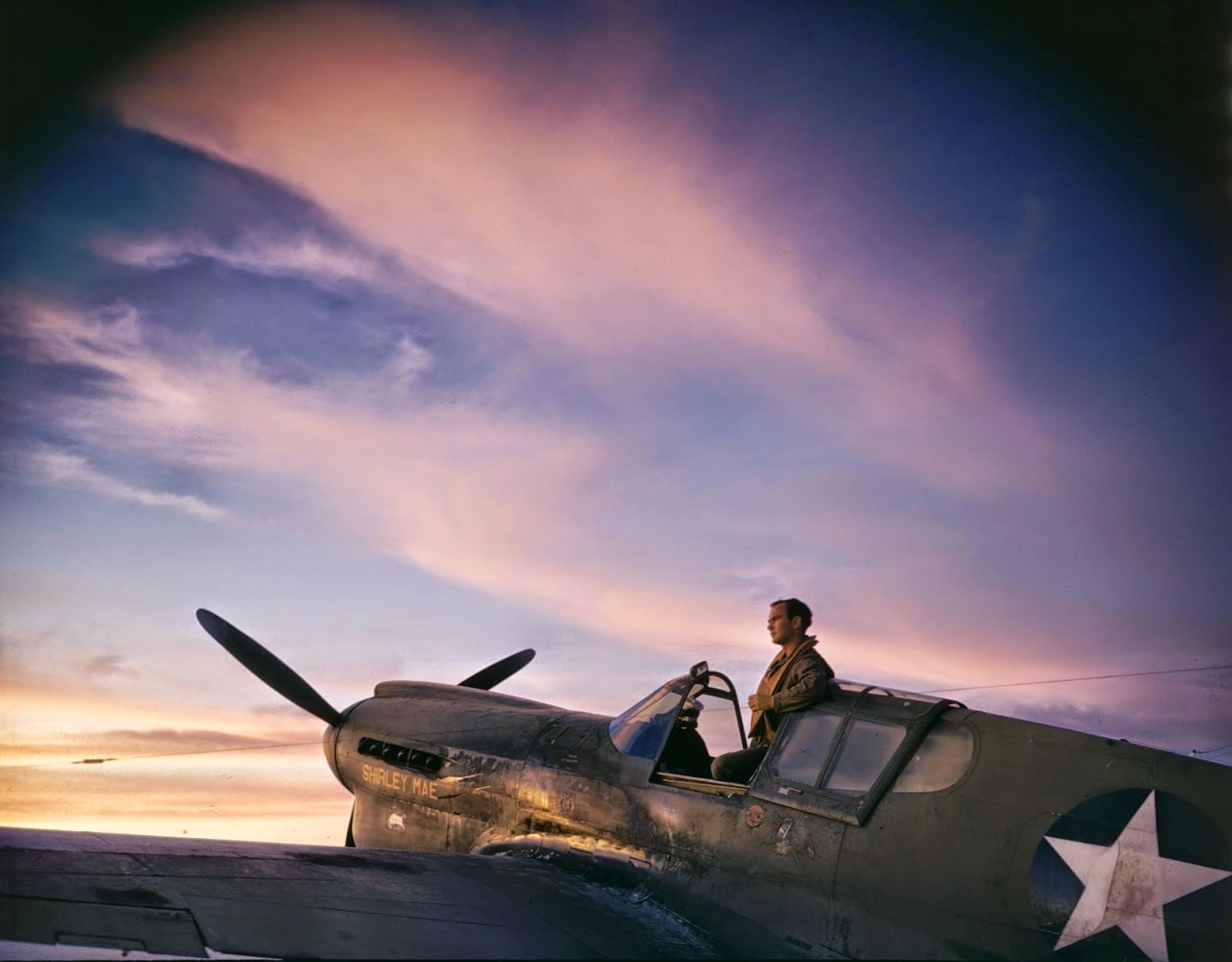 US pilot stands up in the cockpit of his plane on the tarmac on Midway Naval Base, Midway Islands, 1942.