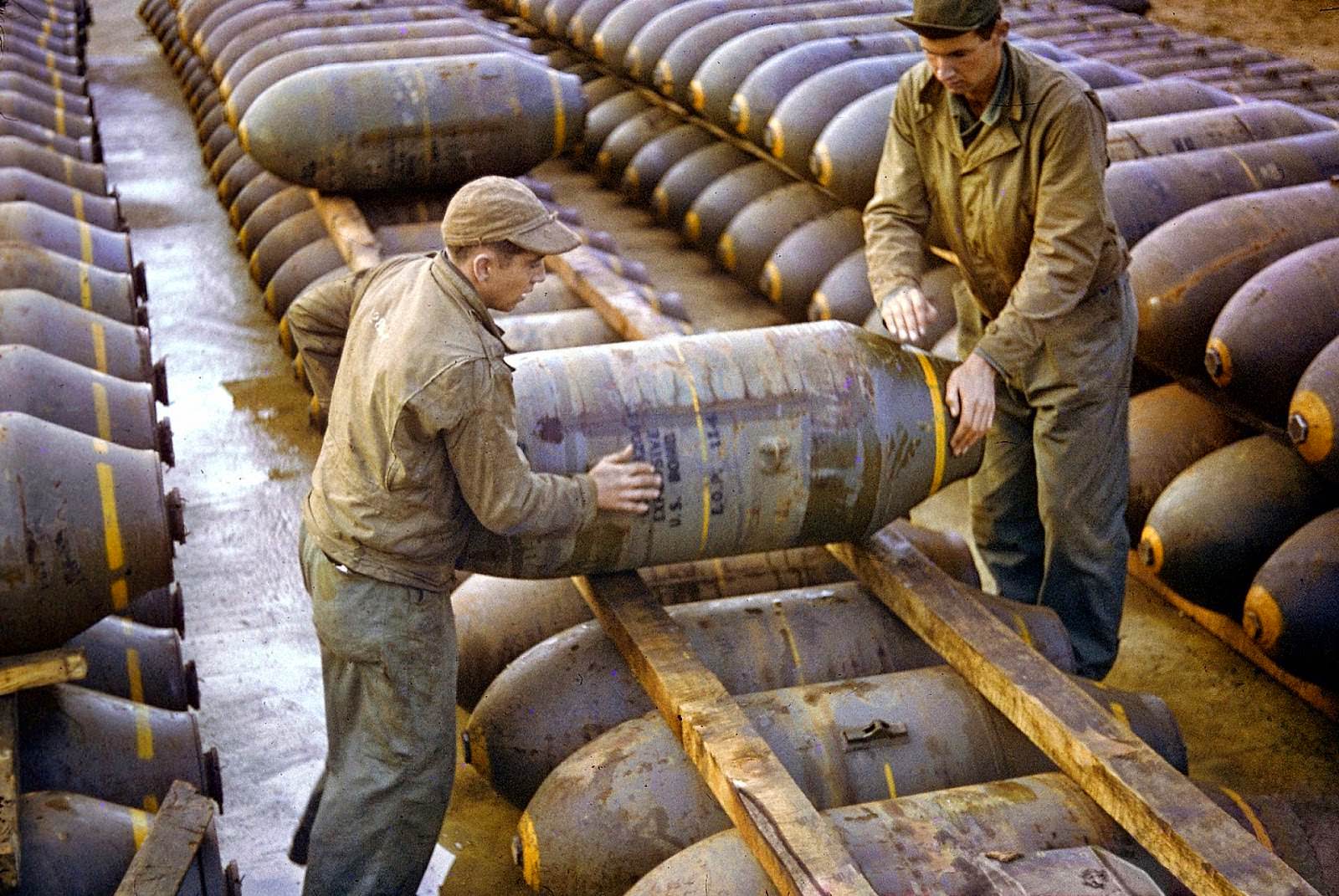 American servicemen moving a large bomb at an ammunition dump in 1944.