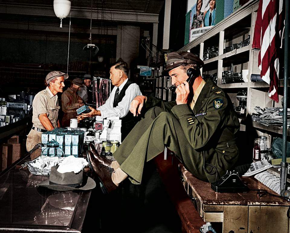 While his father chats with a customer at the hardware store, a uniformed Jimmy Stewart sets up a date to go fishing,1945