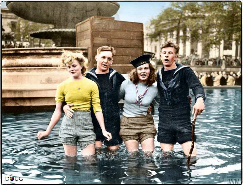 Two British sailors celebrate VE Day with their girlfriends in the fountains at Trafalgar Square. London, England. Tuesday the 8th of May 1945