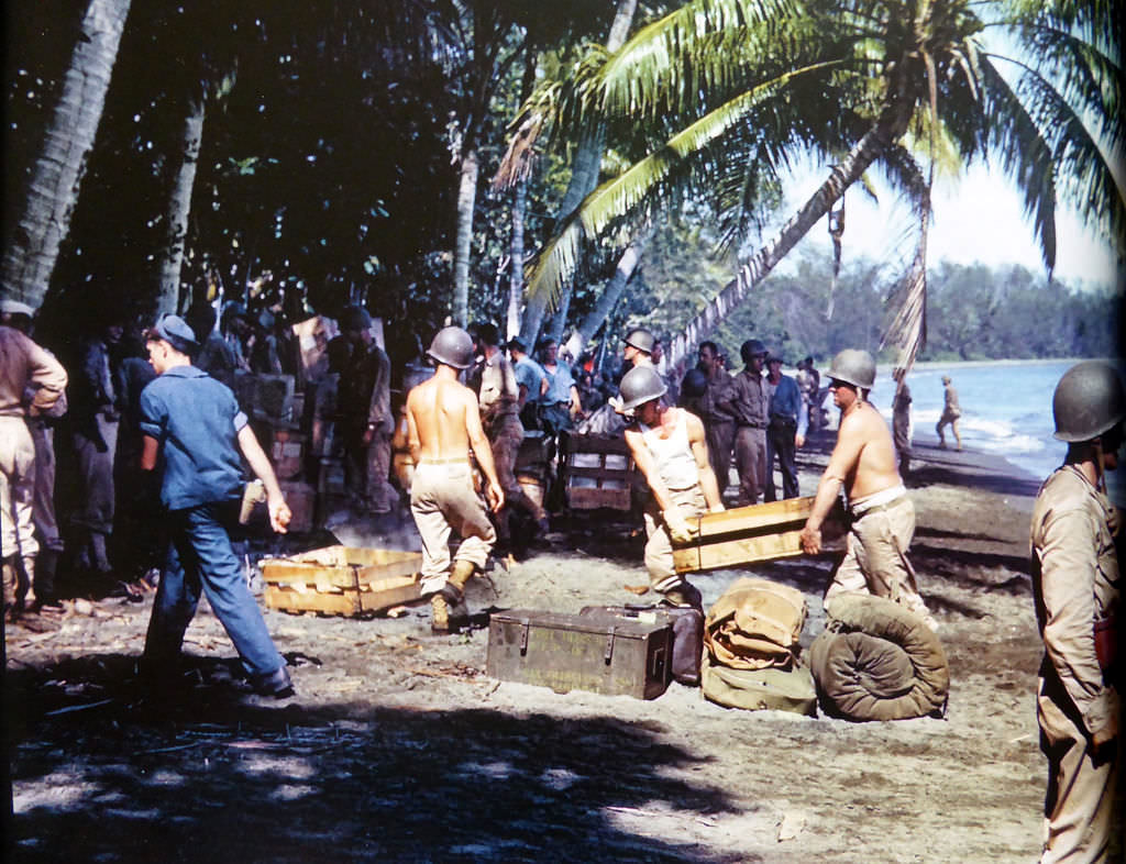 American soldiers and sailors unloaded ammunition and stores on the shore of Guadalcanal, 1942