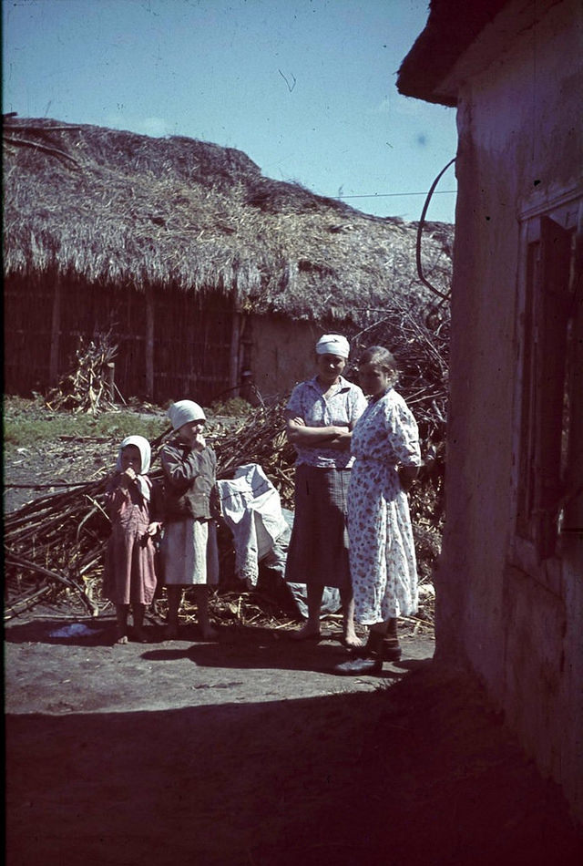 Women with children in a courtyard in one of the occupied village of the Belgorod region, Russia, 1943