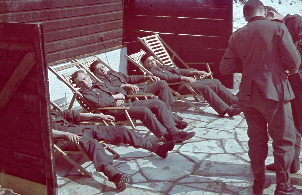 Mountain soldiers of Wehrmacht troops relax on the sun loungers at a hunting lodge