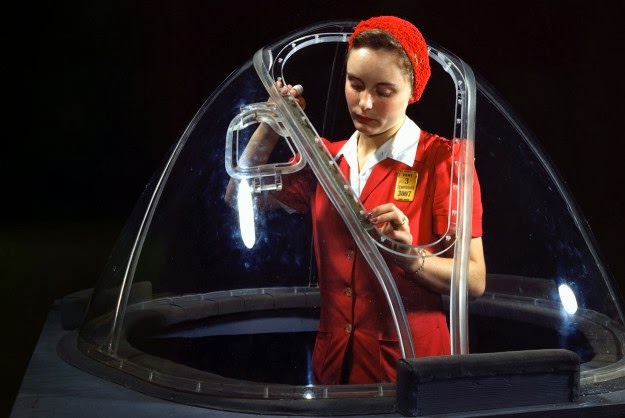 This girl in a glass house is putting finishing touches on the bombardier nose section of a B-17F navy bomber in Long Beach, California, She’s one of many capable women workers in the Douglas Aircraft Company plant.