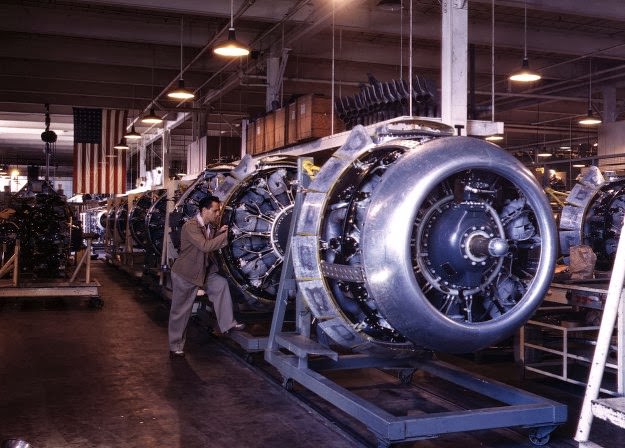 Cowling and control rods are added to motors for North American B-25 bombers as they move down the assembly line at North American Aviation, in Inglewood, California, in October of 1942