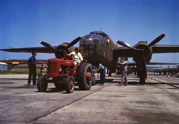 B-25 bomber planes at the North American Aviation, Inc., being hauled along an outdoor assembly line with an “International” tractor, in Kansas City, Kansas, in October, 1942